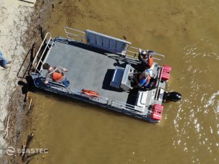 Utility waterway maintenance boat top down with ramp stowed